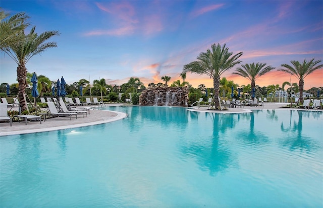 6162 Winding Pine Dr, Nokomis, FL 34275 - pool at dusk featuring a community pool and a patio