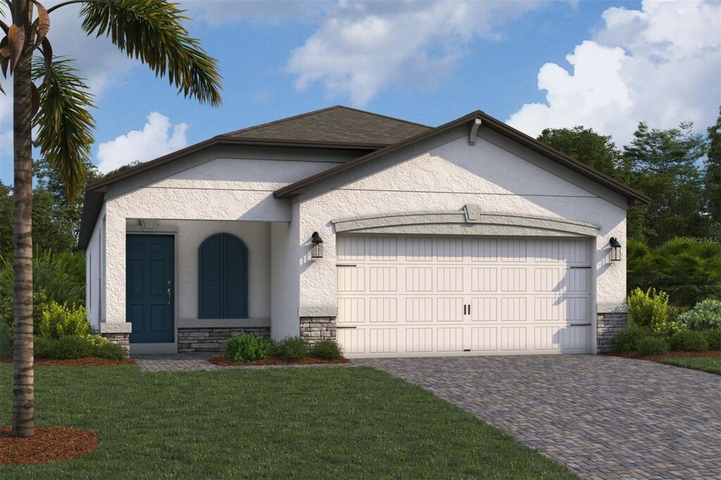 view of front of house featuring a garage, stone siding, stucco siding, a front yard, and driveway