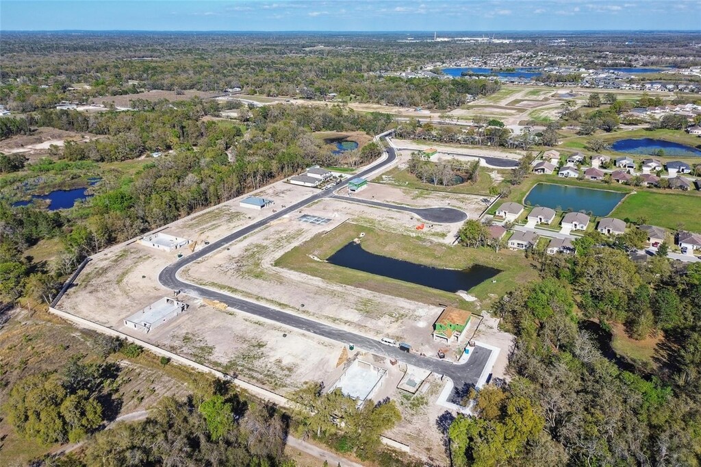 aerial view of property and surrounding area with a nearby body of water