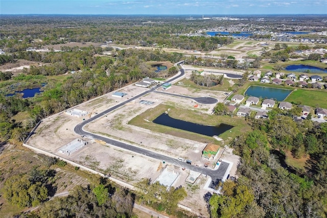 aerial view of property and surrounding area with a nearby body of water