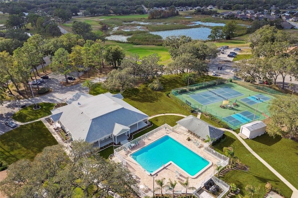 drone / aerial view of a large body of water and a pool area