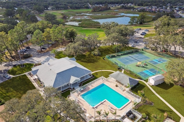 drone / aerial view of a large body of water and a pool area