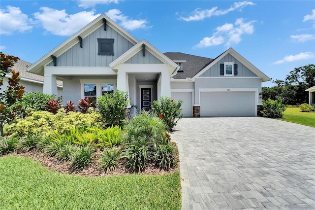 5971 Hidden Branch Dr, Apollo Beach, FL 33572 - craftsman inspired home featuring board and batten siding, decorative driveway, a garage, and a shingled roof