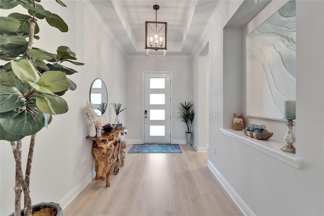 5971 Hidden Branch Dr, Apollo Beach, FL 33572 - foyer featuring wood finished floors, a chandelier, and a tray ceiling