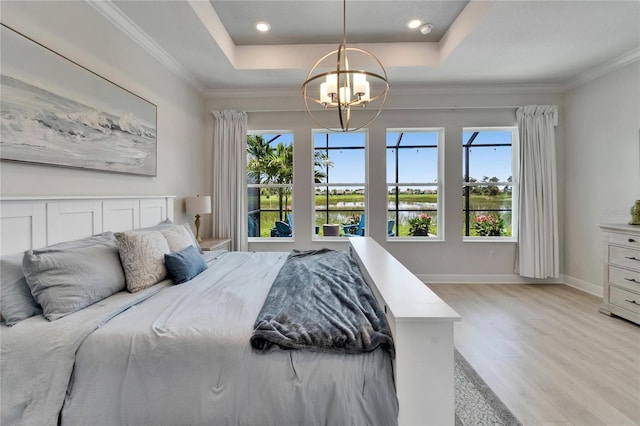 5971 Hidden Branch Dr, Apollo Beach, FL 33572 - bedroom with light wood-type flooring, a raised ceiling, a chandelier, crown molding, and a water view