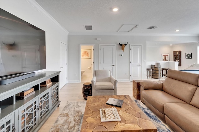 5971 Hidden Branch Dr, Apollo Beach, FL 33572 - living area with crown molding, light wood-style flooring, a textured ceiling, recessed lighting, and attic access