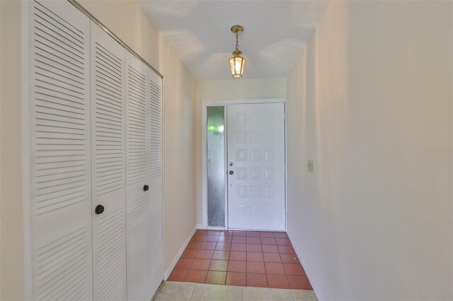 2609 Lancaster Dr, Sun City Center, FL 33573 - foyer entrance with tile patterned floors and a textured ceiling