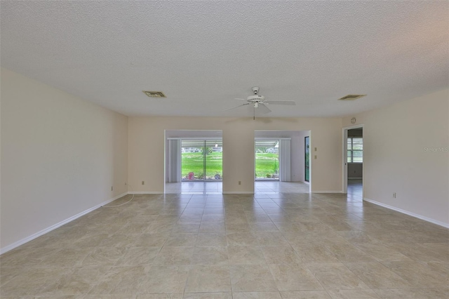 2609 Lancaster Dr, Sun City Center, FL 33573 - spare room with plenty of natural light, ceiling fan, and a textured ceiling