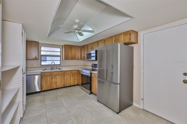 2609 Lancaster Dr, Sun City Center, FL 33573 - kitchen with stainless steel appliances, a ceiling fan, light countertops, and brown cabinets