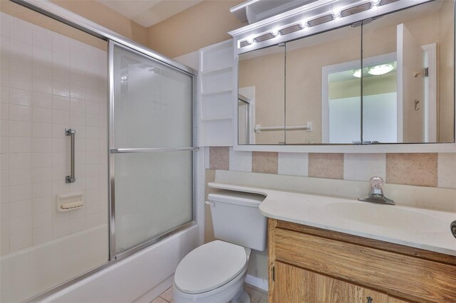 2609 Lancaster Dr, Sun City Center, FL 33573 - bathroom with vanity and bath / shower combo with glass door
