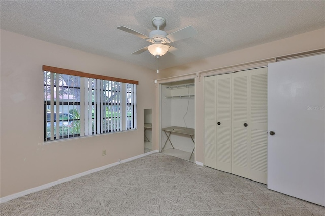 2609 Lancaster Dr, Sun City Center, FL 33573 - unfurnished bedroom with two closets, carpet floors, a textured ceiling, and ceiling fan