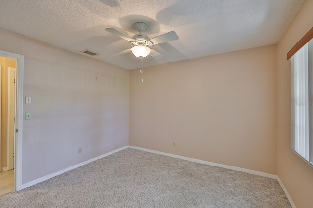 2609 Lancaster Dr, Sun City Center, FL 33573 - unfurnished room with a ceiling fan, light carpet, and a textured ceiling