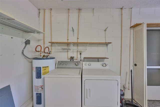 2609 Lancaster Dr, Sun City Center, FL 33573 - laundry room featuring water heater, concrete block wall, and washing machine and dryer