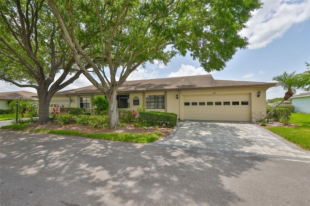 2609 Lancaster Dr, Sun City Center, FL 33573 - single story home with a garage, stucco siding, and driveway