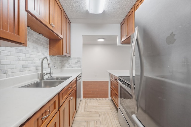 3325 Bayshore Blvd Unit A17, Tampa, FL 33629 - kitchen with stainless steel appliances, brown cabinets, light countertops, and a textured ceiling
