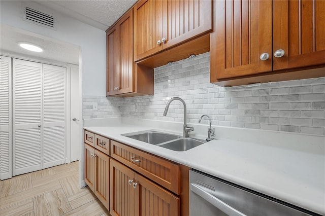 3325 Bayshore Blvd Unit A17, Tampa, FL 33629 - kitchen featuring dishwasher, light countertops, decorative backsplash, brown cabinetry, and a textured ceiling