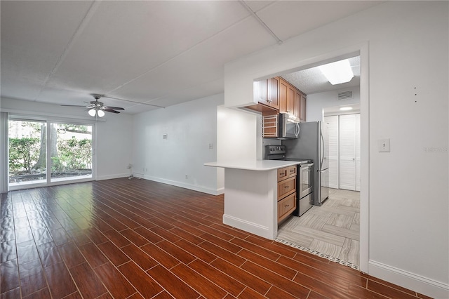 3325 Bayshore Blvd Unit A17, Tampa, FL 33629 - kitchen featuring appliances with stainless steel finishes, ceiling fan, light countertops, open floor plan, and wood finished floors