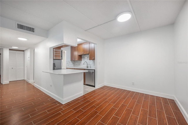 3325 Bayshore Blvd Unit A17, Tampa, FL 33629 - kitchen with dishwasher, wood finished floors, decorative backsplash, and light countertops