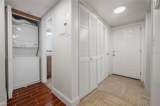 3325 Bayshore Blvd Unit A17, Tampa, FL 33629 - washroom with estacked washer and dryer, electric panel, and wood finished floors