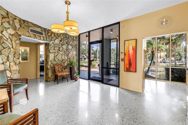 700 Beach Dr NE Unit 602, Saint Petersburg, FL 33701 - building lobby with a textured ceiling and expansive windows