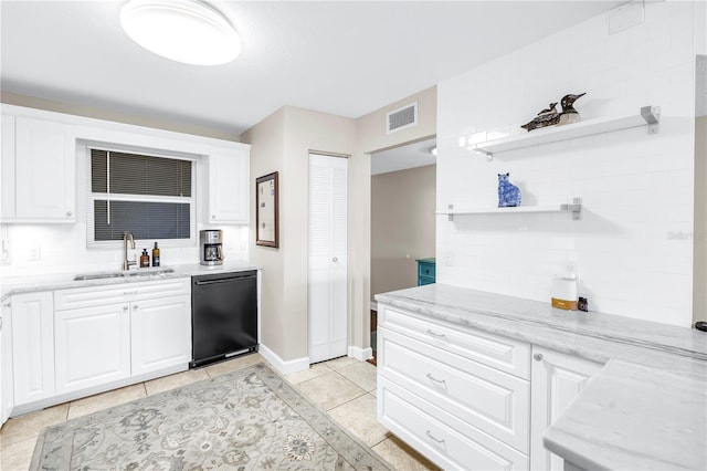 700 Beach Dr NE Unit 602, Saint Petersburg, FL 33701 - kitchen with dishwashing machine, open shelves, white cabinetry, light tile patterned floors, and light stone countertops