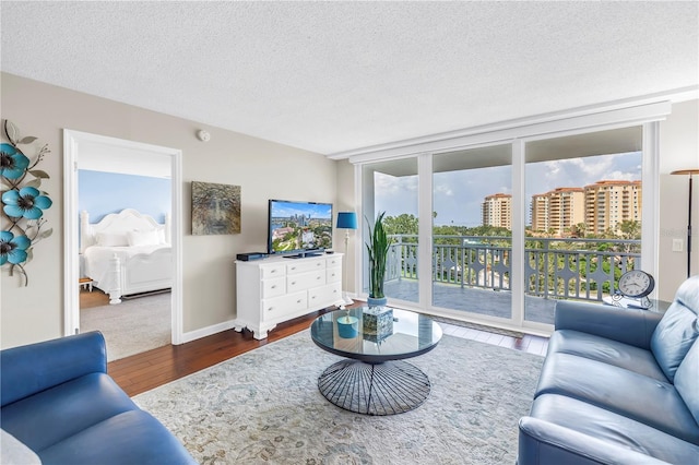700 Beach Dr NE Unit 602, Saint Petersburg, FL 33701 - living area featuring dark wood-style floors, a textured ceiling, and floor to ceiling windows
