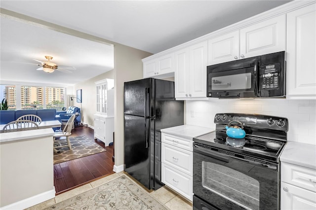 700 Beach Dr NE Unit 602, Saint Petersburg, FL 33701 - kitchen featuring black appliances, backsplash, and light countertops