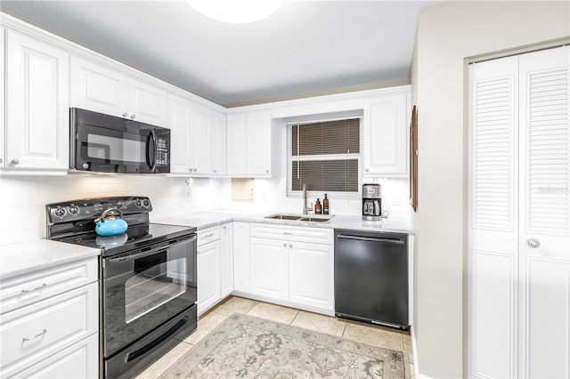 700 Beach Dr NE Unit 602, Saint Petersburg, FL 33701 - kitchen with black appliances, tasteful backsplash, white cabinets, and light tile patterned floors