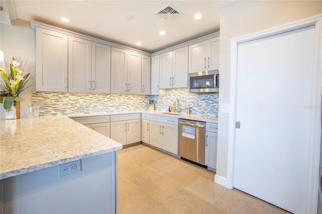 700 Beach Dr NE Unit 602, Saint Petersburg, FL 33701 - kitchen featuring appliances with stainless steel finishes, tasteful backsplash, recessed lighting, and light stone counters