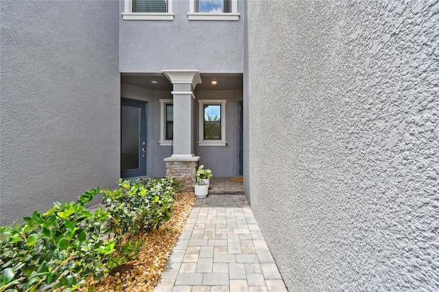 4653 Ancona Way, Wesley Chapel, FL 33543 - view of exterior entry featuring stucco siding