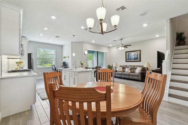 4653 Ancona Way, Wesley Chapel, FL 33543 - dining area featuring stairway, a chandelier, ceiling fan, recessed lighting, and light wood-style flooring