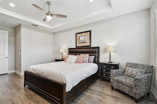 4653 Ancona Way, Wesley Chapel, FL 33543 - bedroom with a raised ceiling, wood finished floors, recessed lighting, and a ceiling fan