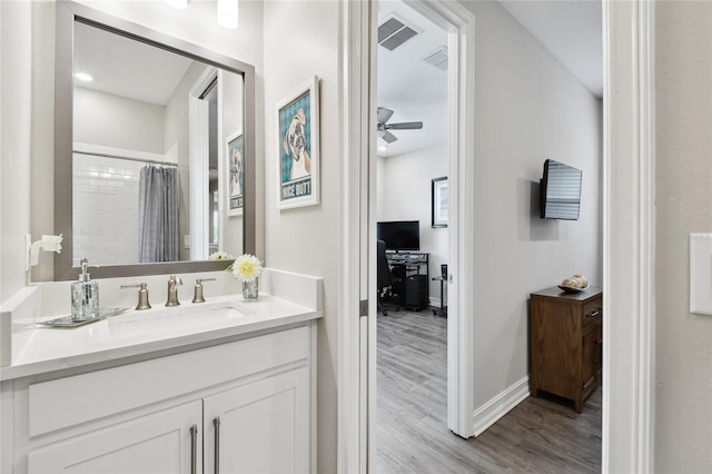 4653 Ancona Way, Wesley Chapel, FL 33543 - bathroom featuring vanity, wood finished floors, ceiling fan, and curtained shower