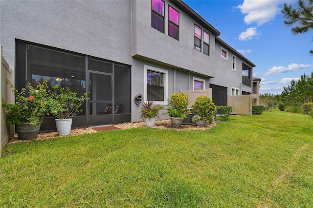 4653 Ancona Way, Wesley Chapel, FL 33543 - rear view of property with stucco siding and a lawn