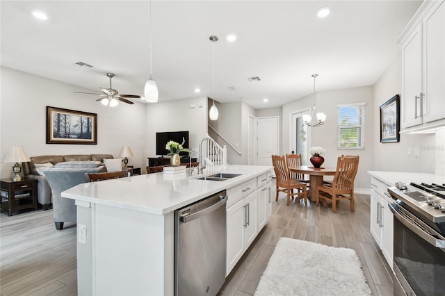 4653 Ancona Way, Wesley Chapel, FL 33543 - kitchen with appliances with stainless steel finishes, light wood finished floors, light countertops, recessed lighting, and white cabinets