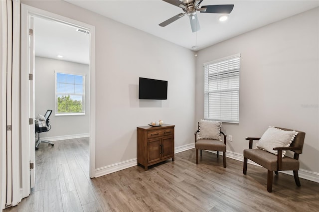4653 Ancona Way, Wesley Chapel, FL 33543 - living area with healthy amount of natural light, a ceiling fan, light wood-style floors, and an office area
