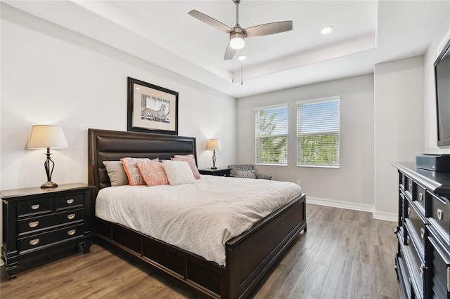4653 Ancona Way, Wesley Chapel, FL 33543 - bedroom with a raised ceiling, light wood-type flooring, a ceiling fan, and recessed lighting