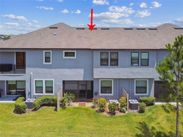 4653 Ancona Way, Wesley Chapel, FL 33543 - rear view of house featuring stucco siding, a lawn, a sunroom, and roof with shingles