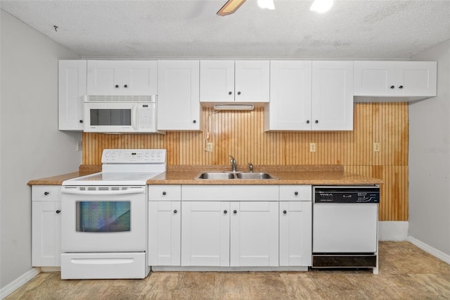 202 Peacock Ln Unit B, Holmes Beach, FL 34217 - kitchen featuring white appliances, white cabinets, a textured ceiling, light countertops, and ceiling fan
