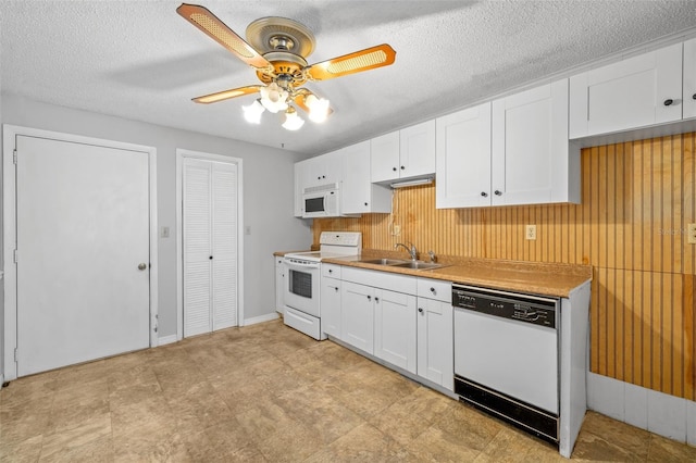 202 Peacock Ln Unit B, Holmes Beach, FL 34217 - kitchen featuring white appliances, a ceiling fan, white cabinetry, light countertops, and wood walls