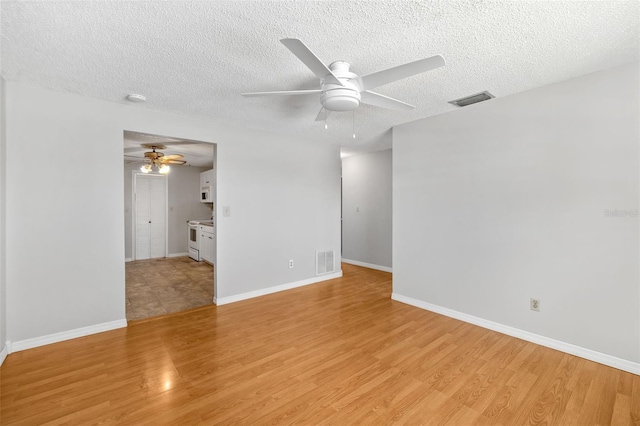 202 Peacock Ln Unit B, Holmes Beach, FL 34217 - empty room with a ceiling fan, light wood-type flooring, and a textured ceiling