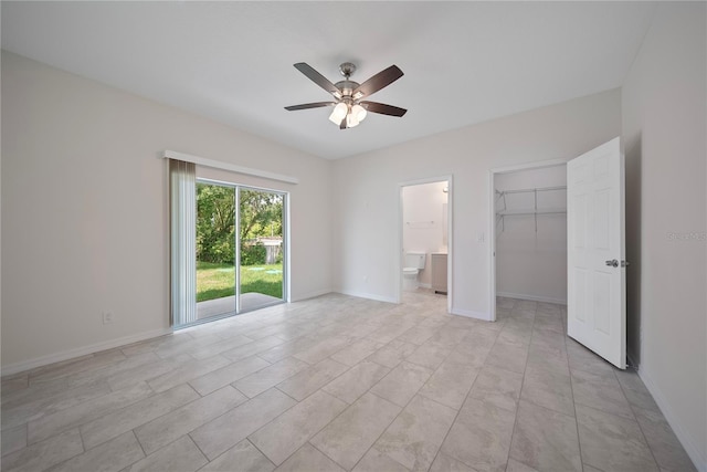 2810 N 75th St, Tampa, FL 33619 - unfurnished bedroom featuring connected bathroom, a spacious closet, a ceiling fan, and a closet