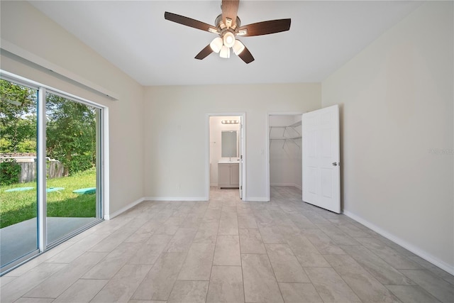 2810 N 75th St, Tampa, FL 33619 - unfurnished bedroom featuring a ceiling fan, a walk in closet, a closet, and connected bathroom