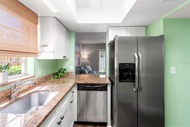 1011 S Moody Ave Unit 11, Tampa, FL 33629 - kitchen with appliances with stainless steel finishes, white cabinetry, and light stone countertops