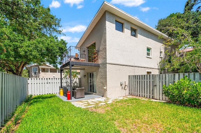 1011 S Moody Ave Unit 11, Tampa, FL 33629 - rear view of house featuring a balcony, stucco siding, a fenced backyard, and a patio area
