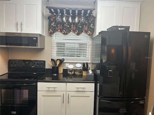 2500 Winding Creek Blvd Unit B105, Clearwater, FL 33761 - kitchen with black appliances, white cabinets, and dark countertops