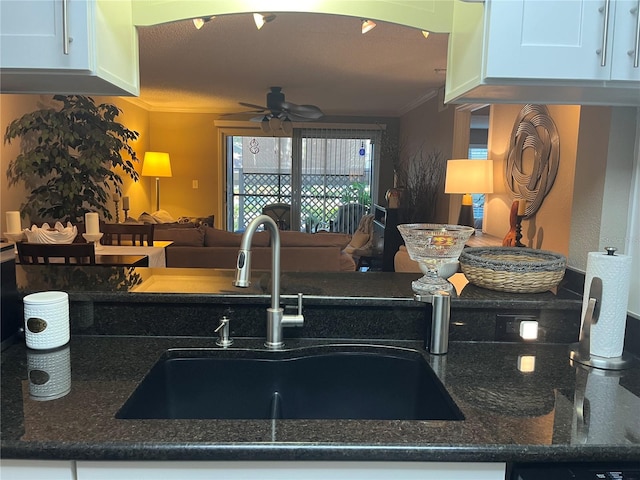 2500 Winding Creek Blvd Unit B105, Clearwater, FL 33761 - kitchen featuring ornamental molding, a ceiling fan, white cabinets, dark stone counters, and open floor plan