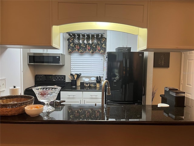 2500 Winding Creek Blvd Unit B105, Clearwater, FL 33761 - kitchen with black appliances, dark stone counters, and white cabinetry