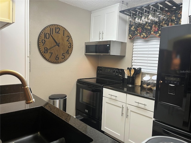 2500 Winding Creek Blvd Unit B105, Clearwater, FL 33761 - kitchen with black appliances, a textured ceiling, and white cabinetry