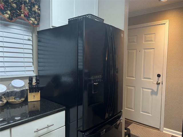 2500 Winding Creek Blvd Unit B105, Clearwater, FL 33761 - kitchen with black refrigerator with ice dispenser, crown molding, white cabinetry, and dark stone countertops